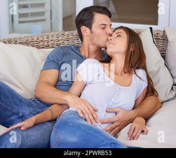 Relaxed romance. a loving married couple cuddling and being affectionate at home. Stock Photo