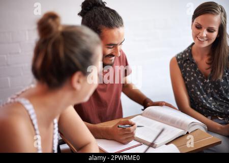 Helping each other during class. young college students working together in class. Stock Photo