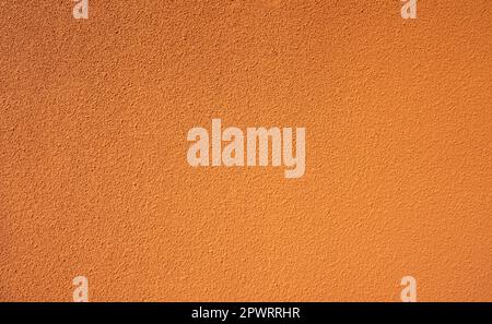 Orange rough concrete wall texture background. Empty orange concrete wall abstract background. Full frame orange cement wall texture background. Blank Stock Photo
