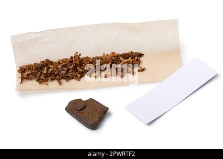 Ingredients for a joint with a piece of afghan hash isolated on white background close up Stock Photo