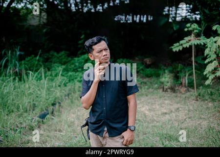 a man who was thinking about something in the forest area Stock Photo
