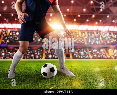 Football player ready to kick the soccerball at stadium Stock Photo