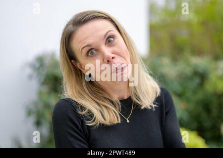 Attractive woman funny sticking out her tongue and making funny grimace Stock Photo