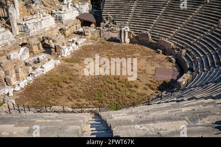 A view across the inside of the well preserved amphitheatre in the ancient Roman city of Side in Antalya Province, Turkey (Turkiye). The Roman amphith Stock Photo