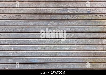 Grunge metal garage door texture background, distressed fragment close up with scratches and aging details Stock Photo