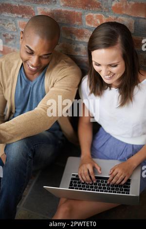 Working on their project after class. two students working on an assignment together. Stock Photo