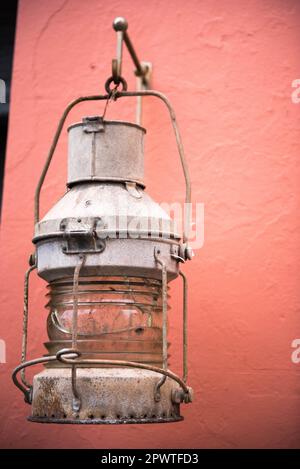 Wall hanging metal fisherman's lantern on a pink wall in Cornish fishing village of Cawsand, England, United Kingdom, Europe Stock Photo