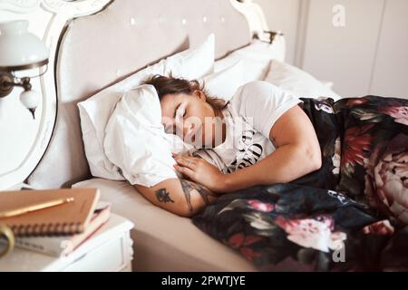 For when she wakes up, shell conquer the world. a beautiful young woman sleeping in her bed Stock Photo