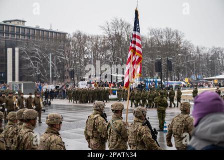 Estonia's NATO ally - United States military armed forces holding the US flag in the Tallinn main square marching in the parade celebration Stock Photo