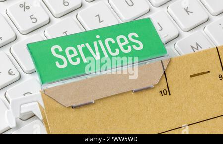 A brown file folder labeled Services Stock Photo