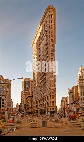 New York’s iconic Flatiron Building, viewed from the north, just as sun clears the east horizon in January 2017. Stock Photo