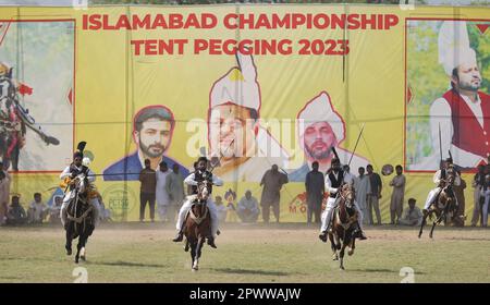 Islamabad. 30th Apr, 2023. Horse riders compete during a tent pegging ...