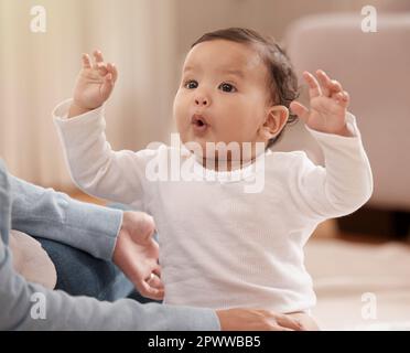 The beginning of a wonderfully big personality. an adorable baby girl sharing a playful moment with her mother at home Stock Photo