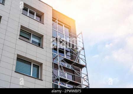 External wall insulation of multistory for energy saving. Exterior house wall heat insulation with mineral wool, building under construction. Stock Photo