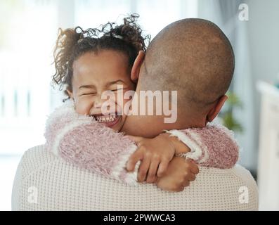 Never forget to cherish every single moment. an adorable little girl embracing her father Stock Photo