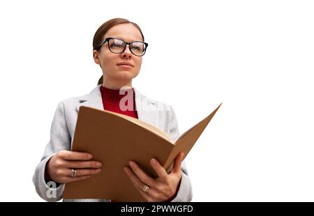 Brunette woman wearing glasses and smart casual attire holding notebook in her hands. Stock Photo