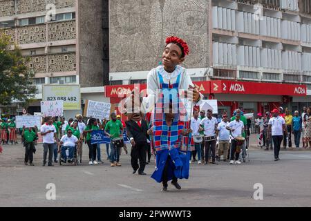 Protesters March with Drums and Giant Puppets in Africa Demanding Equal Rights for People with Disabilities Stock Photo