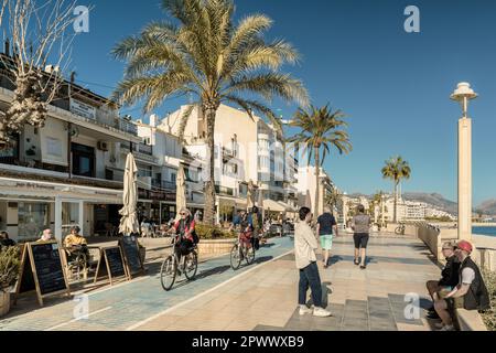 tourists walking and a couple cycling along the promenade in the municipality of Altea, Alicante province, Comunidad Valenciana, Spain, Europe Stock Photo