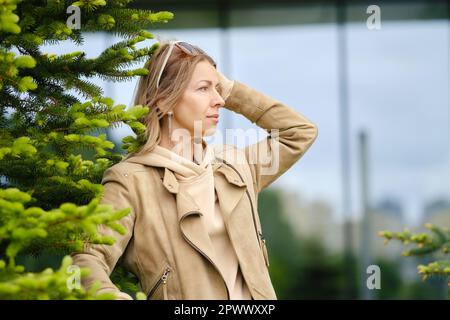 Pretty middle-aged woman looks into the distance Stock Photo