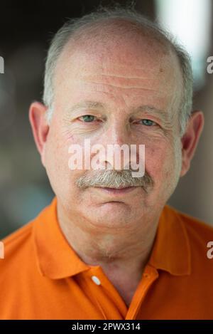 Portrait of grey haired senior man with mustache wearing eyeglasses Stock Photo