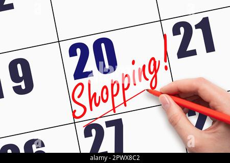 20th day of the month.  Hand writing text SHOPPING and drawing a line on calendar date. Business online sale black Friday advertising concept  Day of Stock Photo