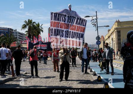 Izmir, Turkey. 01st May, 2023. An old man seen carrying a large banner. International Workers' Day, also known as 'Labour Day' or just 'May Day' is celebrated in Izmir Gündo?du Square. It is a celebration of the working classes and happen every year on 1 May. Credit: SOPA Images Limited/Alamy Live News Stock Photo