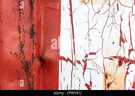 Close-up of an old red and white rusty container with blows as abstract background Stock Photo