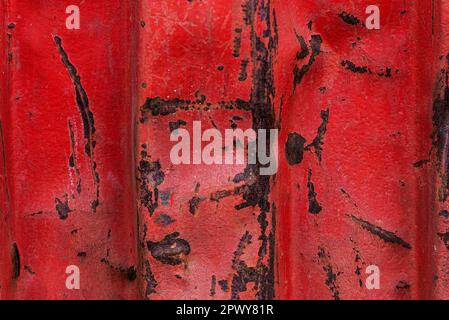 Close-up of an old red rusty container with blows as abstract background Stock Photo