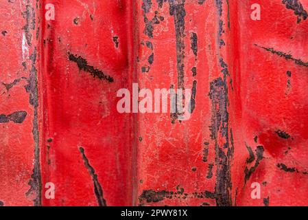 Close-up of an old red rusty container with blows as abstract background Stock Photo