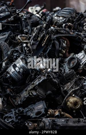 Container with engines and parts of motorcycles and cars piled up as scrap metal for recycling Stock Photo