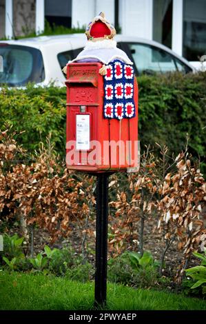 A coronation themed crocheted post box topper celebrating the coronation of His Majesty, King Charles III, 1st May 2023 Stock Photo