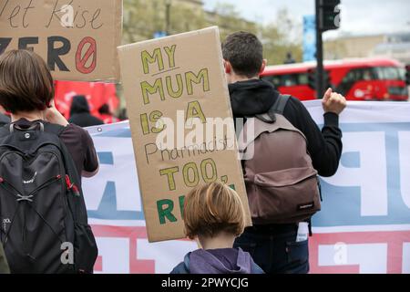 London, UK. 01st May, 2023. A child of a nurse holds a placard on May Day reading 'My mum is a pharmacist too' during the march from St Thomas' Hospital to Trafalgar Square in London . Nurses march from St Thomas' Hospital to Trafalgar Square in central London on May Day on strike for 24 hours over pay, recruitment and retention in the national health service. Credit: SOPA Images Limited/Alamy Live News Stock Photo