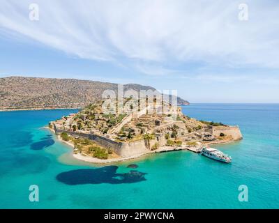 Aerial drone view of Spinalonga island with calm sea. Old venetian fortress island and former leper colony. Stock Photo
