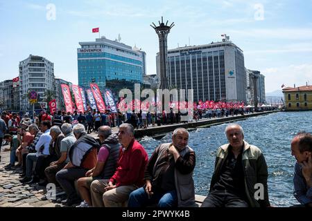 Izmir, Turkey. 01st May, 2023. People sitting by the sea and others walking behind. International Workers' Day, also known as 'Labour Day' or just 'May Day' is celebrated in Izmir Gündo?du Square. It is a celebration of the working classes and happen every year on 1 May. Credit: SOPA Images Limited/Alamy Live News Stock Photo