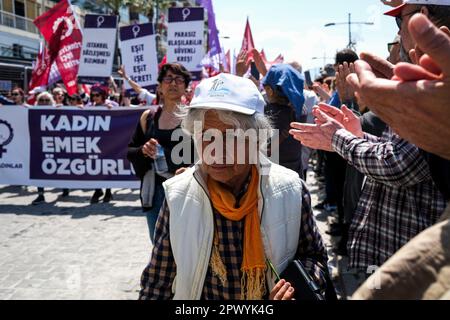 Izmir, Turkey. 01st May, 2023. A woman walks among people clapping. International Workers' Day, also known as 'Labour Day' or just 'May Day' is celebrated in Izmir Gündo?du Square. It is a celebration of the working classes and happen every year on 1 May. Credit: SOPA Images Limited/Alamy Live News Stock Photo