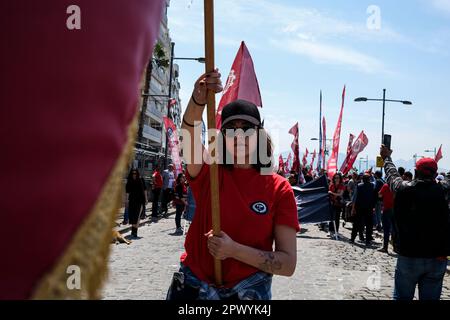 Izmir, Turkey. 01st May, 2023. A woman carrying a pennant. International Workers' Day, also known as 'Labour Day' or just 'May Day' is celebrated in Izmir Gündo?du Square. It is a celebration of the working classes and happen every year on 1 May. Credit: SOPA Images Limited/Alamy Live News Stock Photo