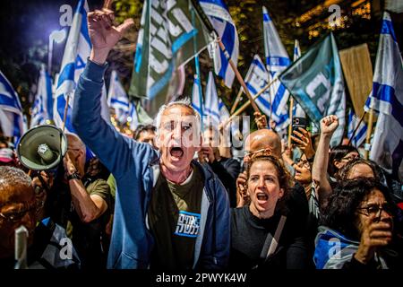 Tel Aviv, Israel. 30th Apr, 2023. Protestors wave Israeli flags and chant slogans as they demonstrate in support of former chief Justice Aharon Barak in Tel Aviv. Hundreds of pro and anti-judicial reform protesters gathered outside the home of former High Court Justice president Aharon Barak on Sunday, after anti-reform groups expressed concern for his safety earlier in the day. Credit: SOPA Images Limited/Alamy Live News Stock Photo
