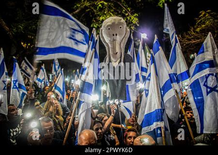 Tel Aviv, Israel. 30th Apr, 2023. Protestors wave Israeli flags and a sign as they demonstrate in support of former chief Justice Aharon Barak in Tel Aviv. Hundreds of pro and anti-judicial reform protesters gathered outside the home of former High Court Justice president Aharon Barak on Sunday, after anti-reform groups expressed concern for his safety earlier in the day. (Photo by Eyal Warshavsky/ SOPA Images/Sipa USA) Credit: Sipa USA/Alamy Live News Stock Photo