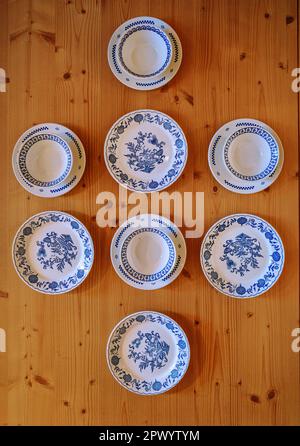 Top view of various porcelain decorated dishes on wooden table Stock Photo