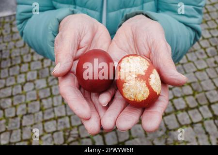 Woman is holding two easter eggs in her hands Stock Photo