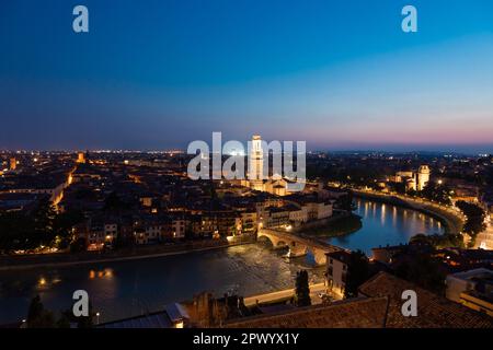 Verona, Italy - June 2022: panorama by night. Illuminated cityscape with scenic bridge Stock Photo