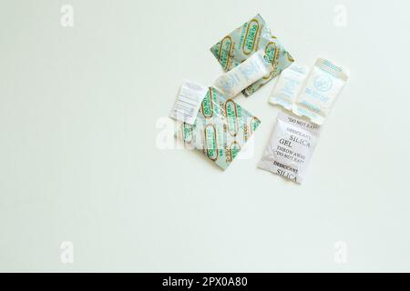 Assorted desiccant and humidity absorbing packets used in products that require dry or arid conditions; moisture absorbents for shipping and packing. Stock Photo