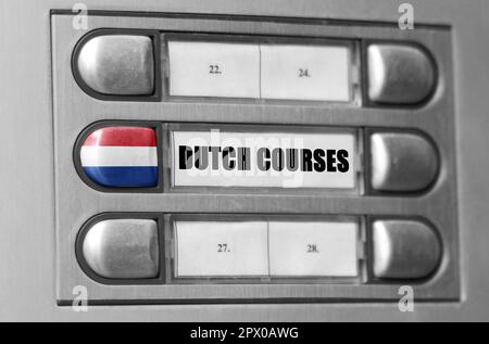 On the intercom there is a button with the flag of the Netherlands and the inscription - Dutch Language Courses. Stock Photo