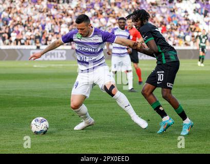 Branko Pauljevic of Ujpest FC competes for the ball with Tokmac