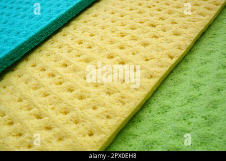 A set of cleaning wipes, microfiber cloths or sponges for the kitchen, three multi-colored cloths. Sponge fibers sponge texture pattern surface close- Stock Photo