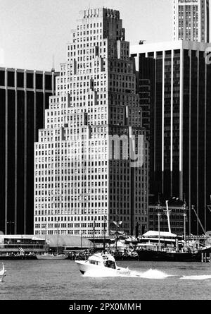 AJAXNETPHOTO. JULY, 1975. NEW YORK, USA. - LOWER MANHATTAN - ART DECO WEDDING-CAKE STYLE BUILDING KNOWN AS 120 WALL STREET OVER LOOKING THE EAST RIVER. DESIGNED BY ARCHITECT ELY JACQUES KAHN OF BUCHMAN & KAHN AND COMPLETED IN 1930.  PHOTO:JONATHAN EASTLAND/AJAXREF:232404 106 Stock Photo