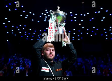 Luca Brecel celebrates with the trophy after beating Mark Selby to win the final on day seventeen of the Cazoo World Snooker Championship at the Crucible Theatre, Sheffield. Picture date: Monday May 1, 2023. Stock Photo