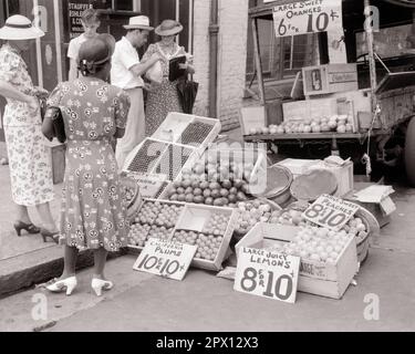 1930s THREE WOMEN HOUSEWIVES PURCHASING FRUITS AND BERRIES FROM A MAN AND BOY FARMERS WITH PICKUP TRUCK PARKED AT CITY CURB - m6467 PAL001 HARS B&W PARKED SHOPPER DRESSES SHOPPERS PICKUP AFRICAN-AMERICANS AFRICAN-AMERICAN AND FARMERS BLACK ETHNICITY HOUSEWIVES CITIES CURB PURCHASING BERRIES FRUITS BLACK AND WHITE CAUCASIAN ETHNICITY CONVENIENCE HIGH HEELS OLD FASHIONED AFRICAN AMERICANS Stock Photo