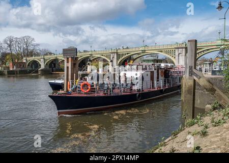A tourist tour boat exiting Richmond Lock and Weir on the River Thames, London, UK. Stock Photo