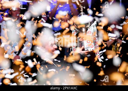 Luca Brecel celebrates with the trophy after beating Mark Selby to win the final on day seventeen of the Cazoo World Snooker Championship at the Crucible Theatre, Sheffield. Picture date: Monday May 1, 2023. Stock Photo